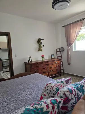 a bedroom with a bed and a dresser and a window at ENCUENTRO 2 BR, Surf, kiting, home Residencial Aris in Cabarete