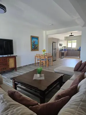 a living room with a couch and a coffee table at ENCUENTRO 2 BR, Surf, kiting, home Residencial Aris in Cabarete