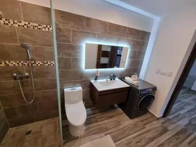 a bathroom with a toilet and a sink and a shower at ENCUENTRO 2 BR, Surf, kiting, home Residencial Aris in Cabarete