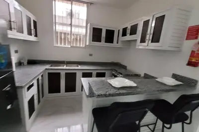 a kitchen with a counter and some chairs in it at Departamento Estrella en Santo Domingo in Santo Domingo