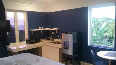 a room with a kitchen with a sink and a window at E&J Boutique Residences in Sosúa