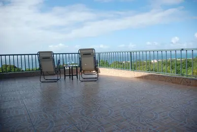 two chairs and a table on top of a balcony at E&J Boutique Residences in Sosúa