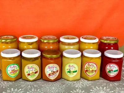 a group of four jars of honey on a shelf at Villa KAMBUSA in Las Galeras