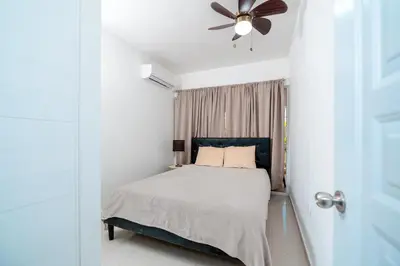 a bedroom with a bed and a ceiling fan at Villa Campo Sosúa - Apartamento in Sosúa