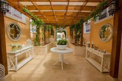 a large room with a table and plants on the walls at Los Flamencos Aparthotel Beach Club in Bayahibe