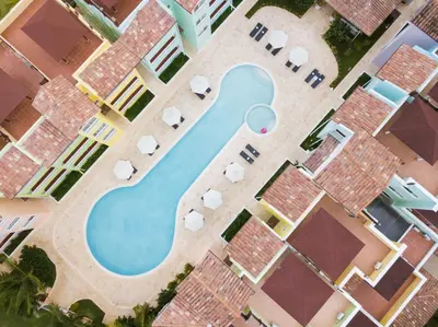 an overhead view of a swimming pool in a resort at Los Flamencos Aparthotel Beach Club in Bayahibe