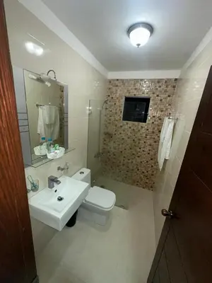 a bathroom with a sink and a toilet and a mirror at Estilo & Confort in Mendoza