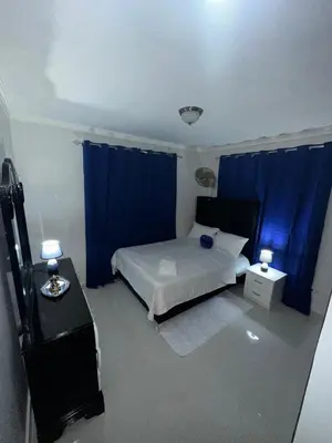 a bedroom with a bed and a blue curtain at Estilo & Confort in Mendoza