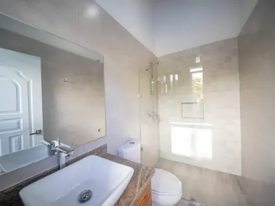 a bathroom with a sink and a toilet and a shower at Villa Selena - 5br Villa In Sosua Center in Sosúa