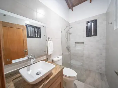 a bathroom with a sink and a toilet and a shower at Villa Selena - 5br Villa In Sosua Center in Sosúa