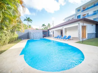 a swimming pool in front of a house at Villa Selena - 5br Villa In Sosua Center in Sosúa