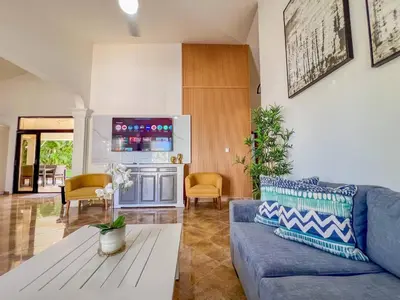 a living room with a blue couch and a table at Villa Selena - 5br Villa In Sosua Center in Sosúa