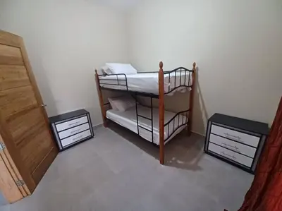 a room with a bunk bed and two night stands at Villa Xiomara in El Jamo