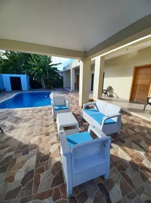 a patio with lounge chairs and a swimming pool at Villa Xiomara in El Jamo