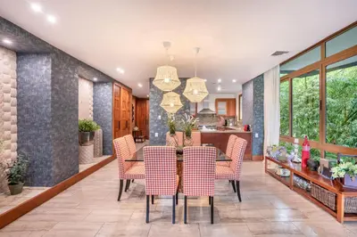 a dining room with a table and chairs at Magical apartment with garden view in Casa de Campo in El Infiernito