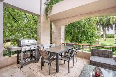 a patio with a grill and a table and chairs at Magical apartment with garden view in Casa de Campo in El Infiernito