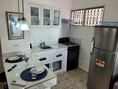 a kitchen with a stainless steel refrigerator and a sink at Cozy Apartment Studio in Santo Domingo