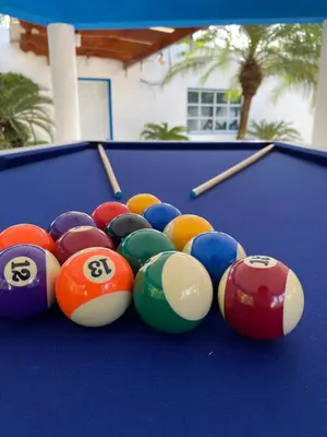 a group of billiard balls on a pool table at Villa El cocotero in La Joya
