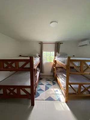 a room with two bunk beds and a window at Villa El cocotero in La Joya