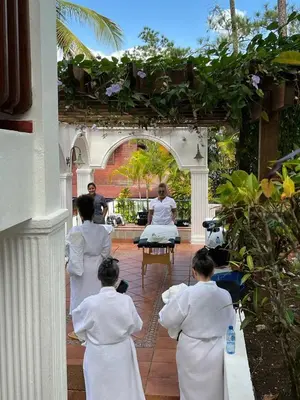 a group of women in white doing yoga in a courtyard at Villa Celeste Bed & Breakfast in El Río Arriba