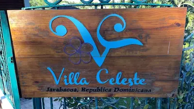 a sign that says villa college on a gate at Villa Celeste Bed & Breakfast in El Río Arriba