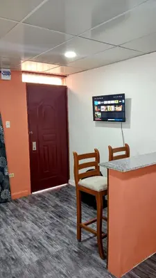a waiting room with two chairs and a red door at Apartamento en la Zona Colonial in Santo Domingo