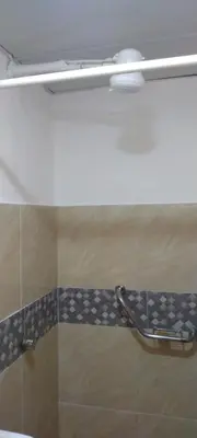 a bathroom with a shower with a towel rack at Apartamento en la Zona Colonial in Santo Domingo