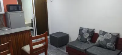 a living room with a couch and a stool at Apartamento en la Zona Colonial in Santo Domingo