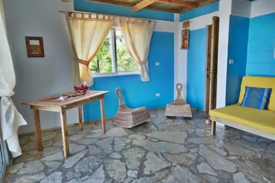 a room with a table and chairs and a window at B&B El Mirador al Mar in Sosúa
