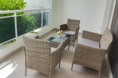 a balcony with a table and chairs and a window at Estrella Dominicus - Excepcional Apartamento en el Caribe in Bayahibe