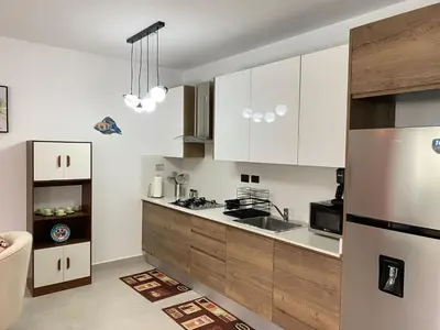 a kitchen with white cabinets and a stainless steel refrigerator at Estrella Dominicus - Excepcional Apartamento en el Caribe in Bayahibe
