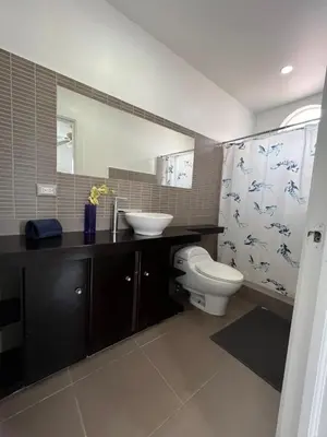 a bathroom with a white toilet and a sink at bello PH cerca de la playa in Punta Cana