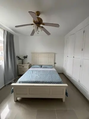 a bedroom with a bed with a ceiling fan at bello PH cerca de la playa in Punta Cana