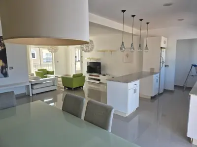 a kitchen and living room with a table and chairs at bello PH cerca de la playa in Punta Cana
