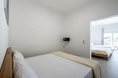 a white room with a bed and a bedroom at Parque Acuático - Sosua! in Laguna del Higüero