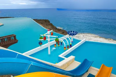 a pool with a water slide in the ocean at Parque Acuático - Sosua! in Laguna del Higüero