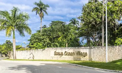 a stone wall with a sign that reads save ocean waves at Parque Acuático - Sosua! in Laguna del Higüero