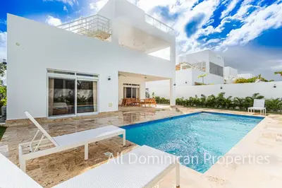 a villa with a swimming pool and a house at Villas Santa Fe in Sosúa
