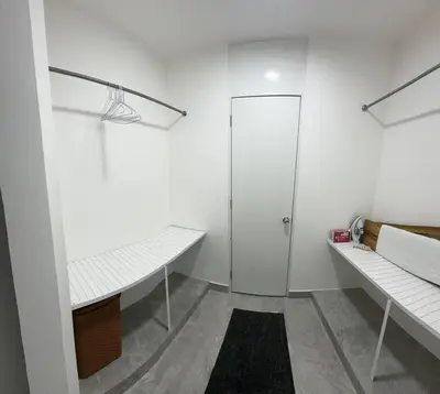 a white room with two benches and a shower at Aire acondicionado Proximo teleférico y ocean Word in San Felipe de Puerto Plata