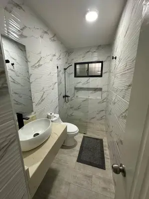 a white bathroom with a sink and a toilet at Aire acondicionado Proximo teleférico y ocean Word in San Felipe de Puerto Plata