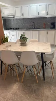 a kitchen with a table with chairs and a sink at Aire acondicionado Proximo teleférico y ocean Word in San Felipe de Puerto Plata