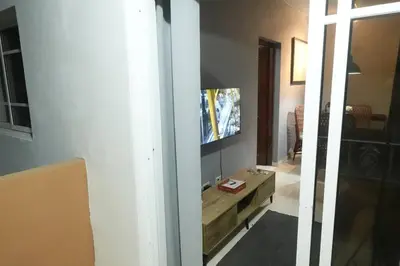 a living room with a tv on a wall at Juan Dolio,Beach, Pool, 40