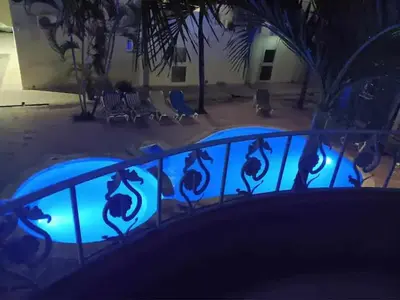 a blue railing in front of a building at night at Juan Dolio,Beach, Pool, 40