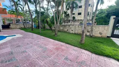 a brick walkway with palm trees and a building at Juan Dolio,Beach, Pool, 40