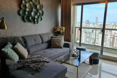 a living room with a couch and a glass table at Luxury penthouse con jacuzzi privado, Gym, pool in Santo Domingo