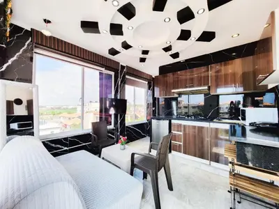 a living room with a large window and a kitchen at Aparta hoteles Corales del Sur in La Viva