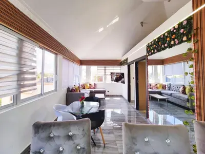 a living room with a table and chairs at Aparta hoteles Corales del Sur in La Viva