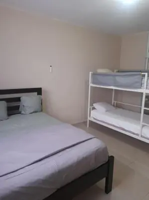 a bedroom with two bunk beds in a room at Maison T4, près de la mer in La Romana