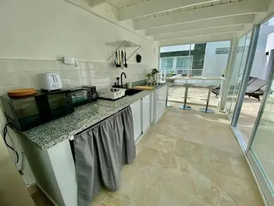 a kitchen with a counter top and a table at Estrella del caribe in La Laguna