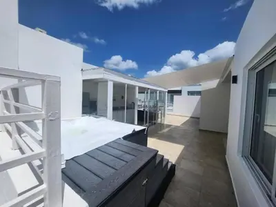 a balcony of a white building with a blue sky at Estrella del caribe in La Laguna